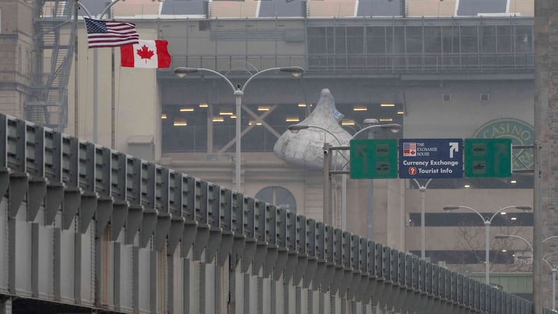 An American flag and Canadian flag are seen on the Rainbow Bridge US-Canada border crossing,...