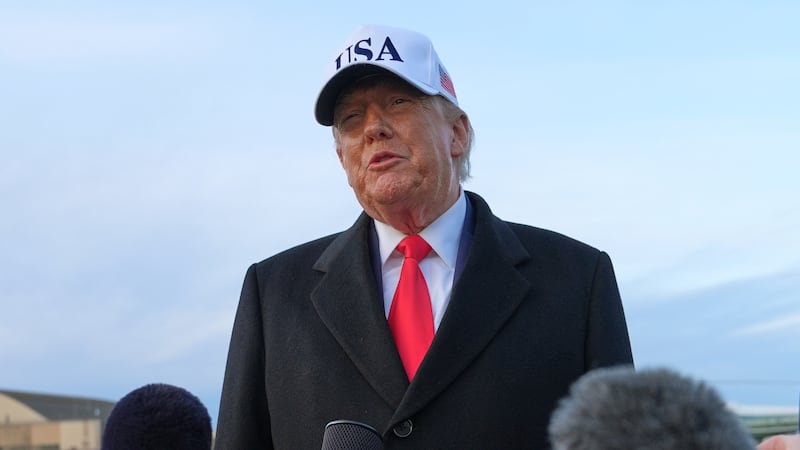 President Donald Trump speaks with reporters at Joint Base Andrews, Tuesday, Jan. 13, 2026, in...
